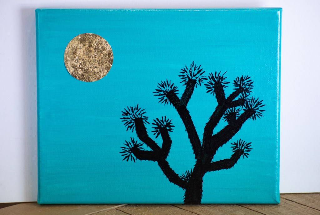 painting of an all black joshua tree with blue background