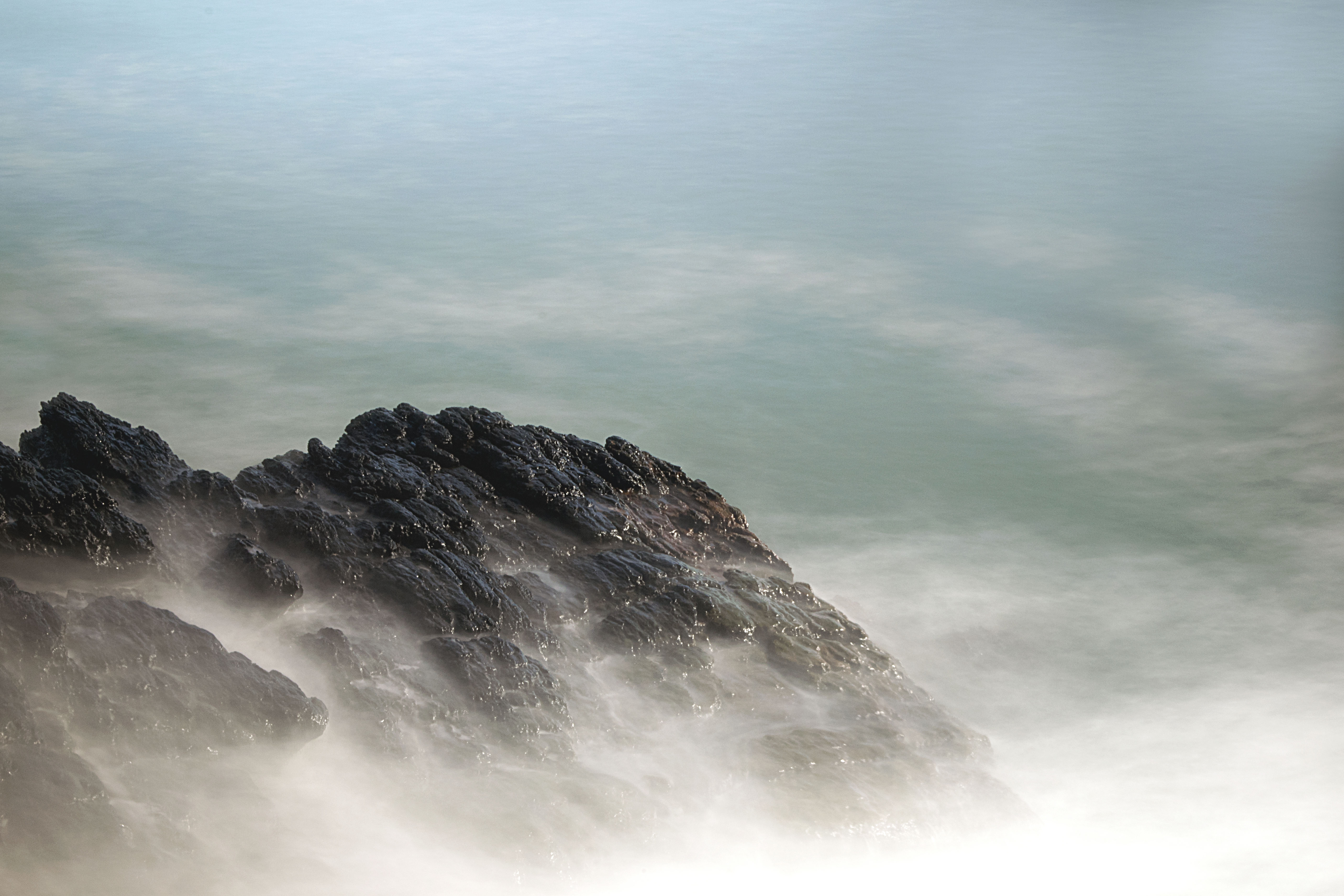 a rock with smokey waves surrounding it